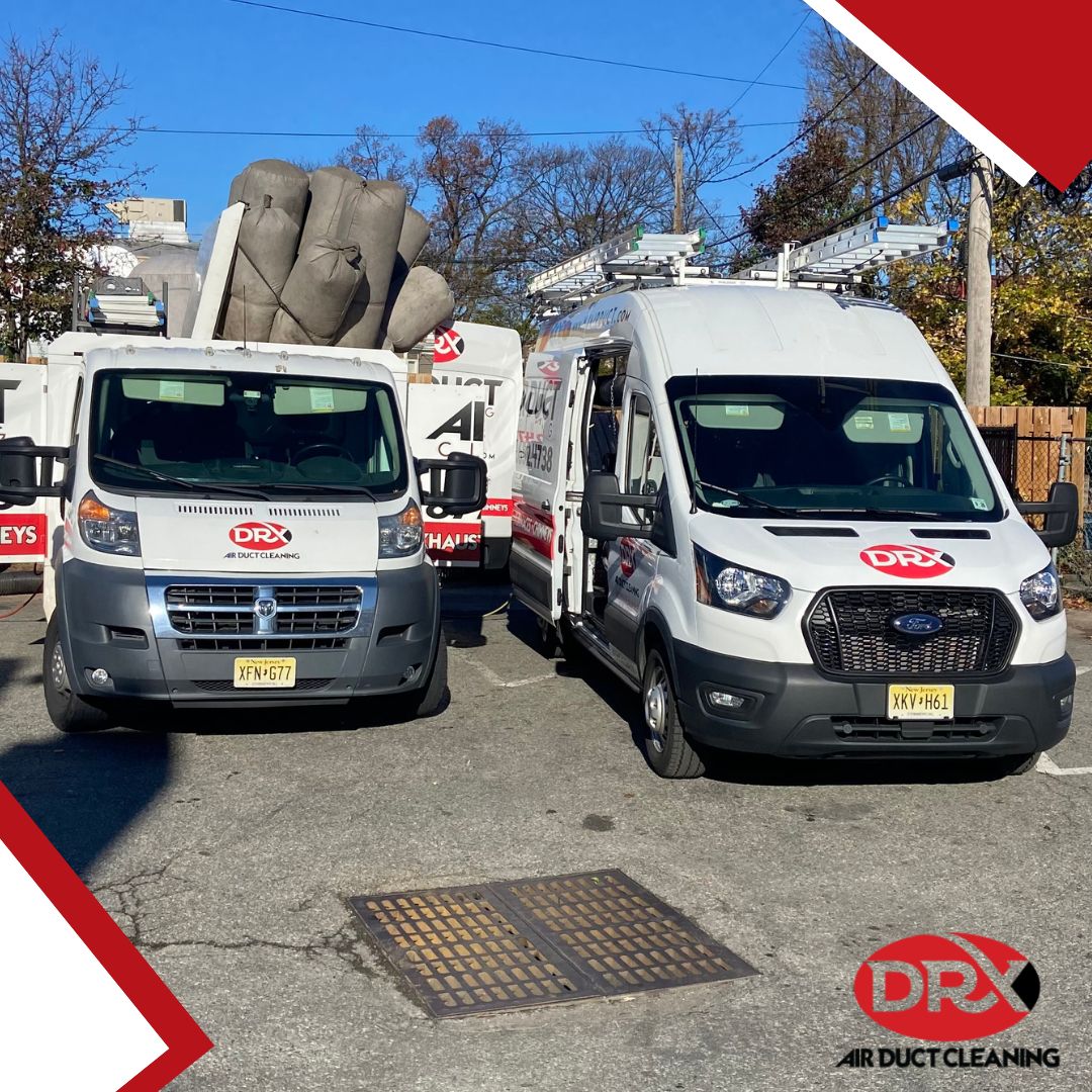 two white DRX trucks parked next to each other ready to clean vents