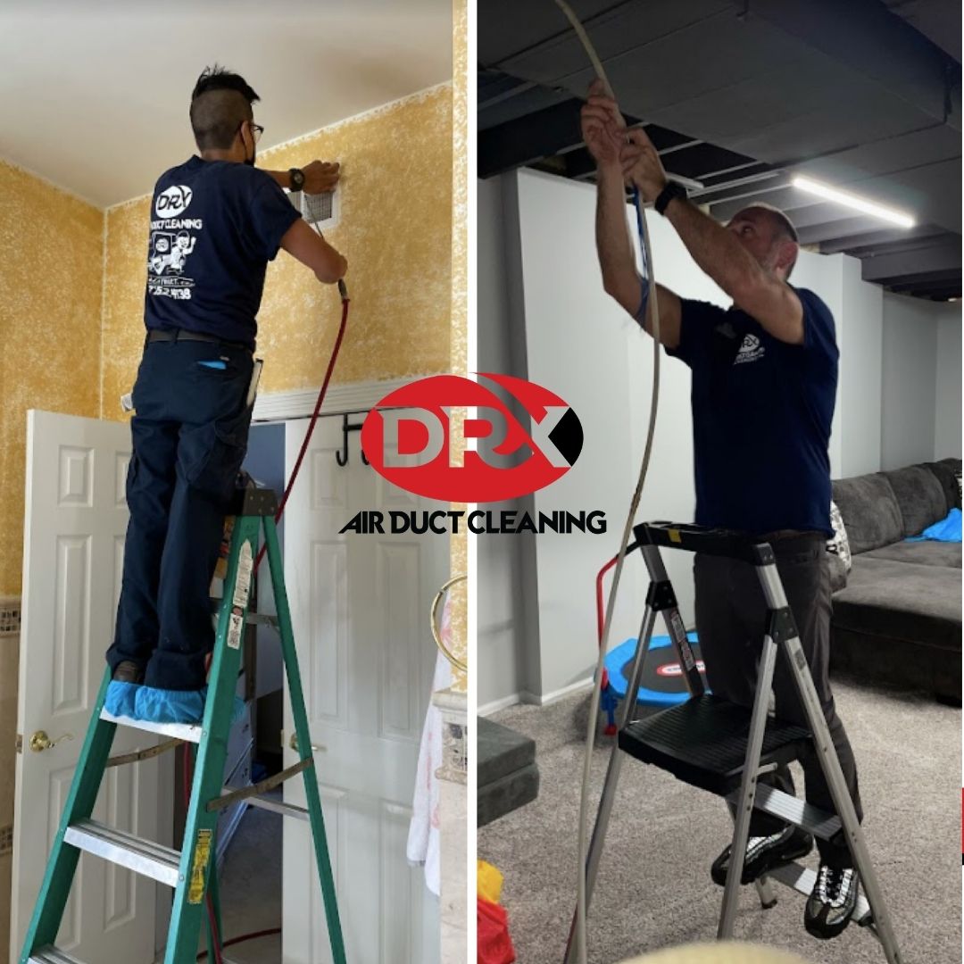 Two professionals from DRX on ladders cleaning ducts