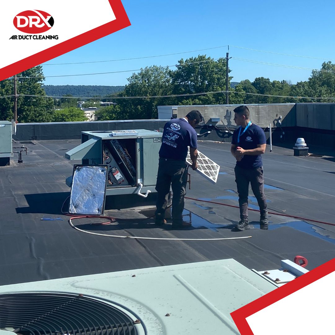 DRX employees cleaning high rise exhaust units