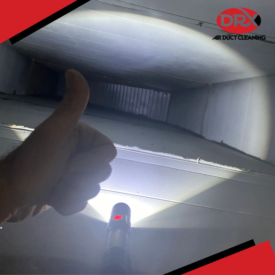A clean duct with a thumbs up from a DRX employee