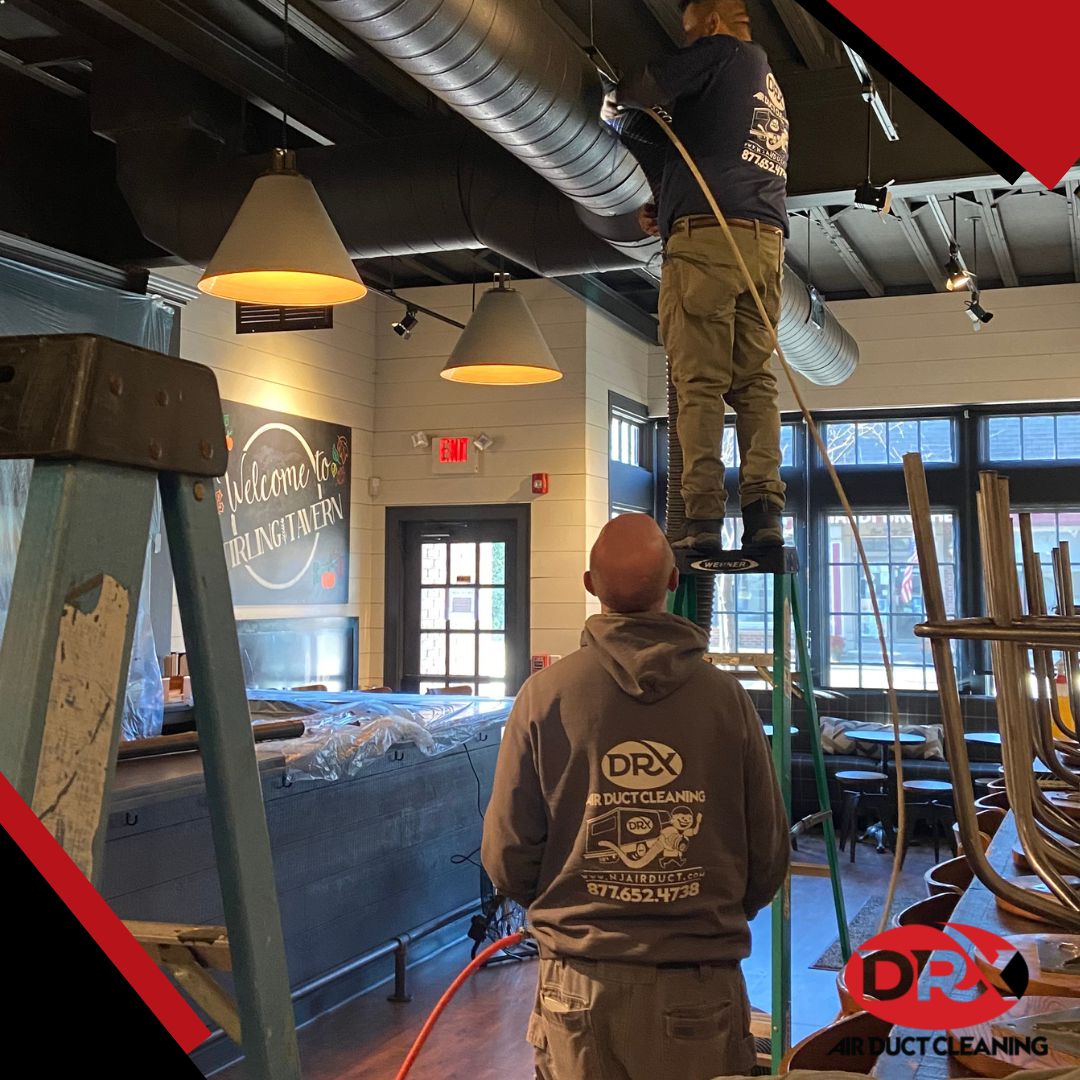 a crew of DRX employees cleaning commercial duct system