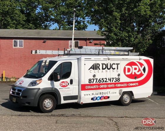 white DRX truck parked in front of house